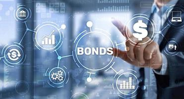 Businessman clicks a bonds virtual screen. Bond Finance Banking Technology concept. Trade Market Network. photo