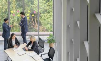 Aerial view of diversity executive business group are casual talking together at modern green office background. photo