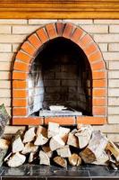 not kindled brick fireplace and wood logs photo