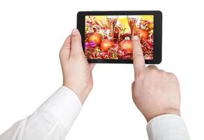 businessman touches tablet pc with Xmas still life photo