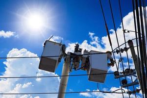 Technician engineer using aerial platform lift truck to service or repair High voltage power cable in the city photo