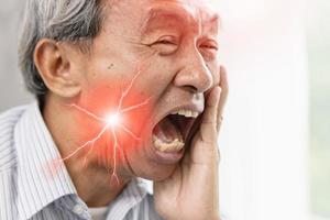 Elder man with severe toothache and hypersensitive teeth.decayed tooth painful face expression. photo