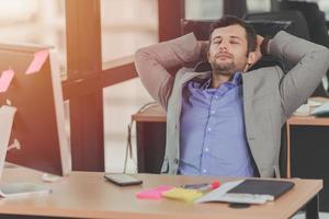 businessman relaxing rest nap after hard work day in the office photo