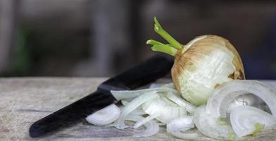 onion with slice onion ring on wooden table background. photo