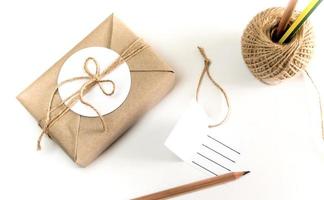 Gift box wrapped in kraft paper and rustic hemp as natural rustic style photo