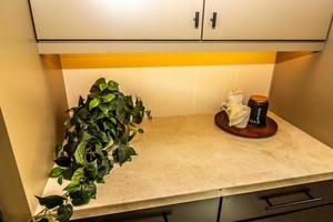 Kitchen Pantry Counter With Plant And Tray With Cups And Container photo