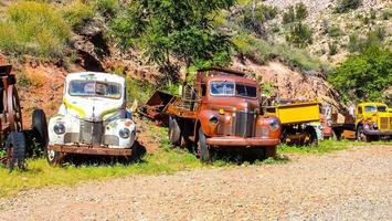 Various Antique Vehicles In Junkyard photo