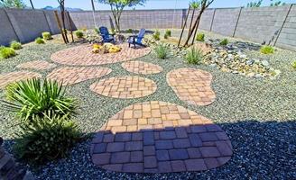 Reaar Yard With Two Arm Chairs, Fire Pit And Various Shapes Of Pavers photo