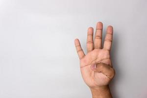 man hand number four gesture. number 4 hand sign isolated on white. pointing the finger photo