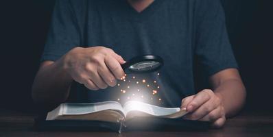 Man reading and search Holy Bible teaching spiritual word book with faith in religion and belief in god. Power of hope and devotion. photo