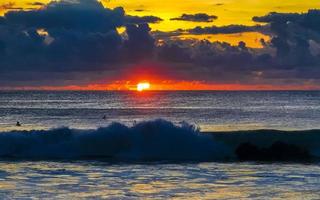 Colorful golden sunset big wave and beach Puerto Escondido Mexico. photo