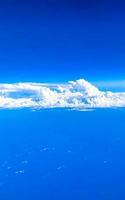 Flying above the clouds with view from the plane window. photo