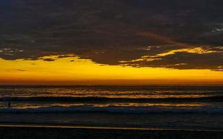 Colorful golden sunset big wave and beach Puerto Escondido Mexico. photo