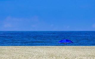 Beach sand blue water huge surfer waves Puerto Escondido Mexico. photo