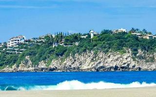 Beach sand blue water huge surfer waves Puerto Escondido Mexico. photo