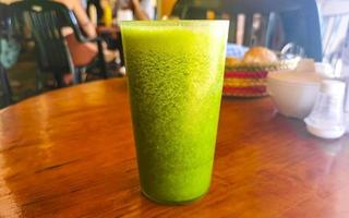 Green healthy juice smoothie in jar in Puerto Escondido Mexico. photo