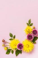 vertical top view of the autumn flowers in the composition. flower frame of yellow and purple dahlias. a copy of the space. a holiday card. photo