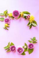 a semicircle of autumn multicolored dahlias. autumn composition. top view. a copy of the space. delicate lilac background. photo