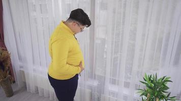 criança infeliz obesa. menino infeliz olhando para sua barriga. video