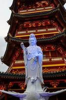 A Pagoda in the center of a Chinatown with the statue of Guan Yin. photo