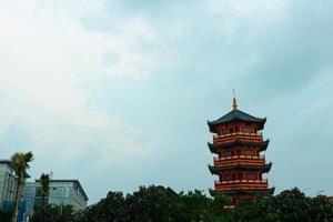 A Pagoda in the center of a Chinatown with the statue of Guan Yin. photo