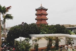 A Pagoda in the center of a Chinatown with the statue of Guan Yin. photo