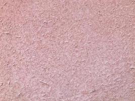 texture, metallic background with coloring. the metal sheet is painted pink. heterogeneous, voluminous texture with splashes of paint. dirt, debris and dust are visible through the paint photo