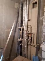 Layout of plastic plumbing pipes with water meters in a new studio apartment in a new building without repair photo