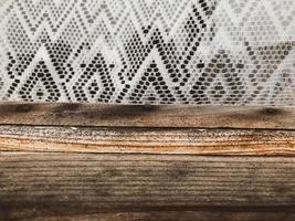 wood texture. wooden house. wood brown, voluminous, textured, cracked. next to the wooden strip is a white patterned tulle. patterned apron. wooden house window photo