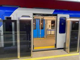 Automatic door platform system at a new modern metro station. Metro security system glass beautiful doors open synchronously with the doors of the arriving train car photo