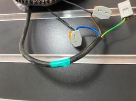 electrical wires in the lamp. wires wrapped with electrical tape at the break points. independent electrical connection, plastic boxes on wires photo