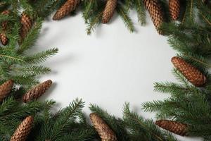 Holidays greeting card or banner composition with pine tree branches. Merry Christmas background and Happy New Year 2023. photo