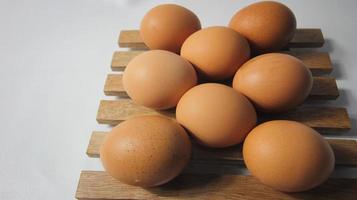 Close up of fresh chicken egg on nature wooden photo