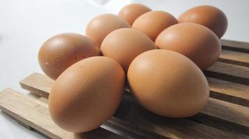 Close up of fresh chicken egg on nature wooden photo