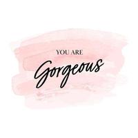 You are gorgeous. Calligraphic quote. Typographic Design. Black hand lettering text on pink  water color background. Vector