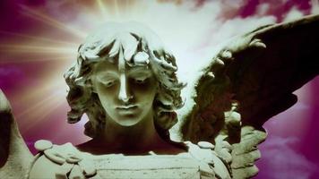 The statue of an Angel on time lapse sunsetting clouds - Loop video