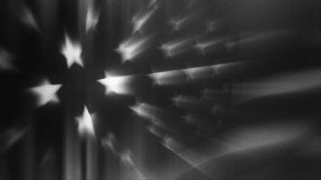 una bandera estadounidense granulada en blanco y negro ondea en la brisa - lazo video