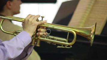 man's hands playing a wind instrument