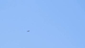 A Jet plane cuts across a clear blue sky video