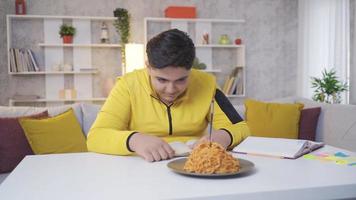 Obese boy paying attention to his eating. The child who wants to eat pasta restrains himself and does not eat. video