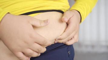 Obesity, abdominal fat. The person holding the belly fat. video