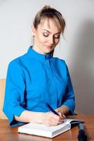 Cutie blonde female doctor working at a desk photo