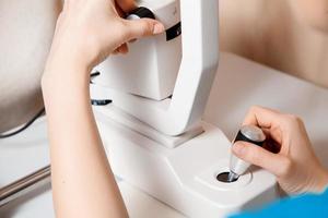 close up Photo of female hands working on the ophthalmic device