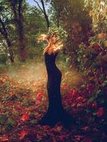 Vertical photo of adorable redhead witch conjures in the woods