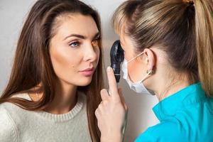 ophthalmologist checks patient eyes with a laser photo