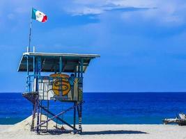 Puerto Escondido Mexico Oaxaca Mexican 2022 Beach watchtower with Mexican flag in Puerto Escondido Mexico. photo