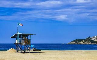 Puerto Escondido Mexico Oaxaca Mexican 2022 Beach watchtower with Mexican flag in Puerto Escondido Mexico. photo