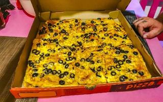 Playa del Carmen Quintana Roo Mexico 2022 Greasy fat huge olive pizza in Playa del Carmen Mexico. photo