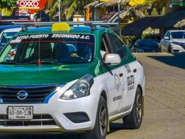 Puerto Escondido Mexico Oaxaca Mexican 2022 Green turquoise blue taxi cab car in Puerto Escondido Mexico. photo