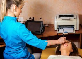 Charming woman checks eyesight ophthalmologist photo